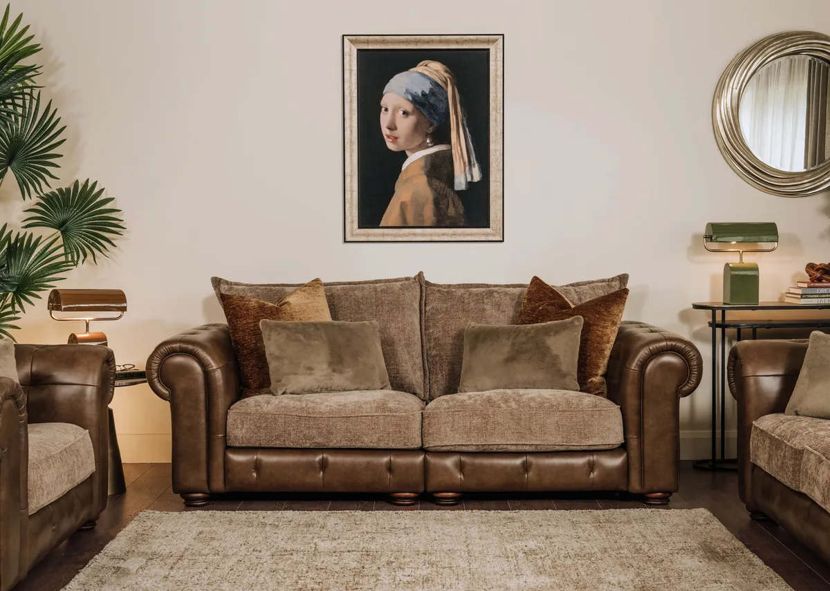 A lifestyle image of the Nepal 3.5 seater sofa with Girl with a Pearl Earring picture and Charleville rug.