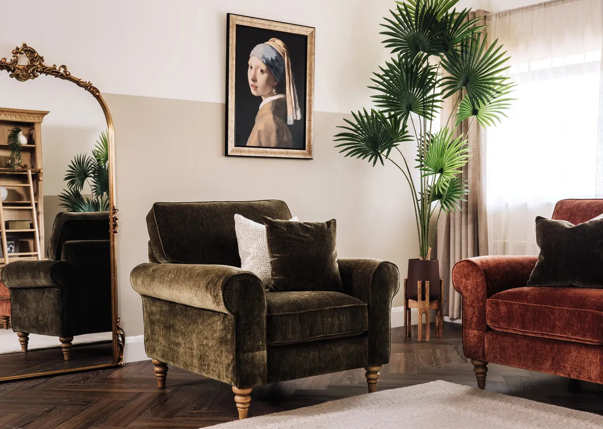 A lifestyle image of the Cotswold armchair with Girl with a pearl earring picture