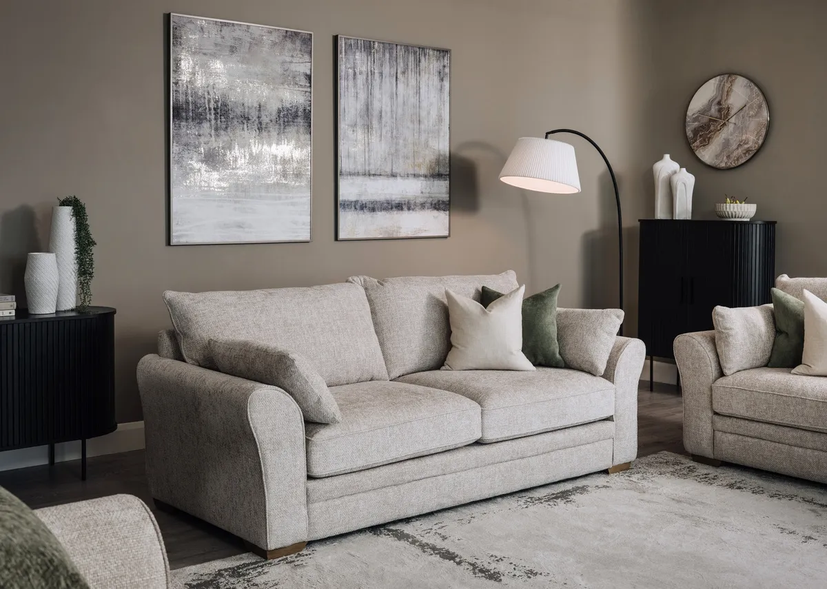 A lifestyle image of the Skyline 3 seater sofa with nola black side table and cabinet.