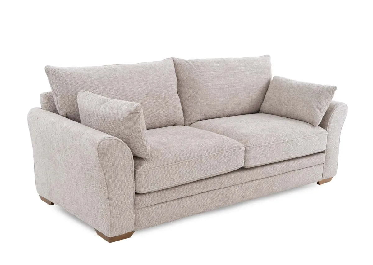A beige fabric 3 seater sofa from EZ Livings Skyline range. Angled view of 2 arm pillows.