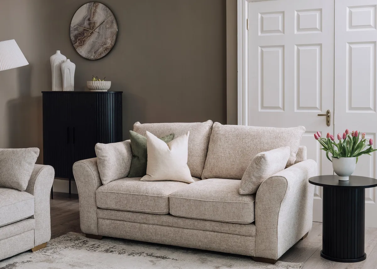 A lifetsyle image of the Skyline 2 seater sofa with nola black side table and cabinet.
