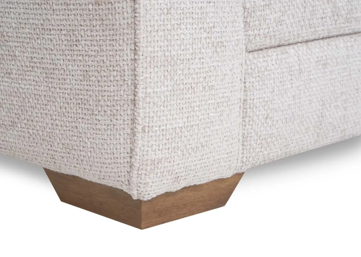 A beige fabric 2 seater sofa from EZ Livings Skyline range.Closeup of wood feet.