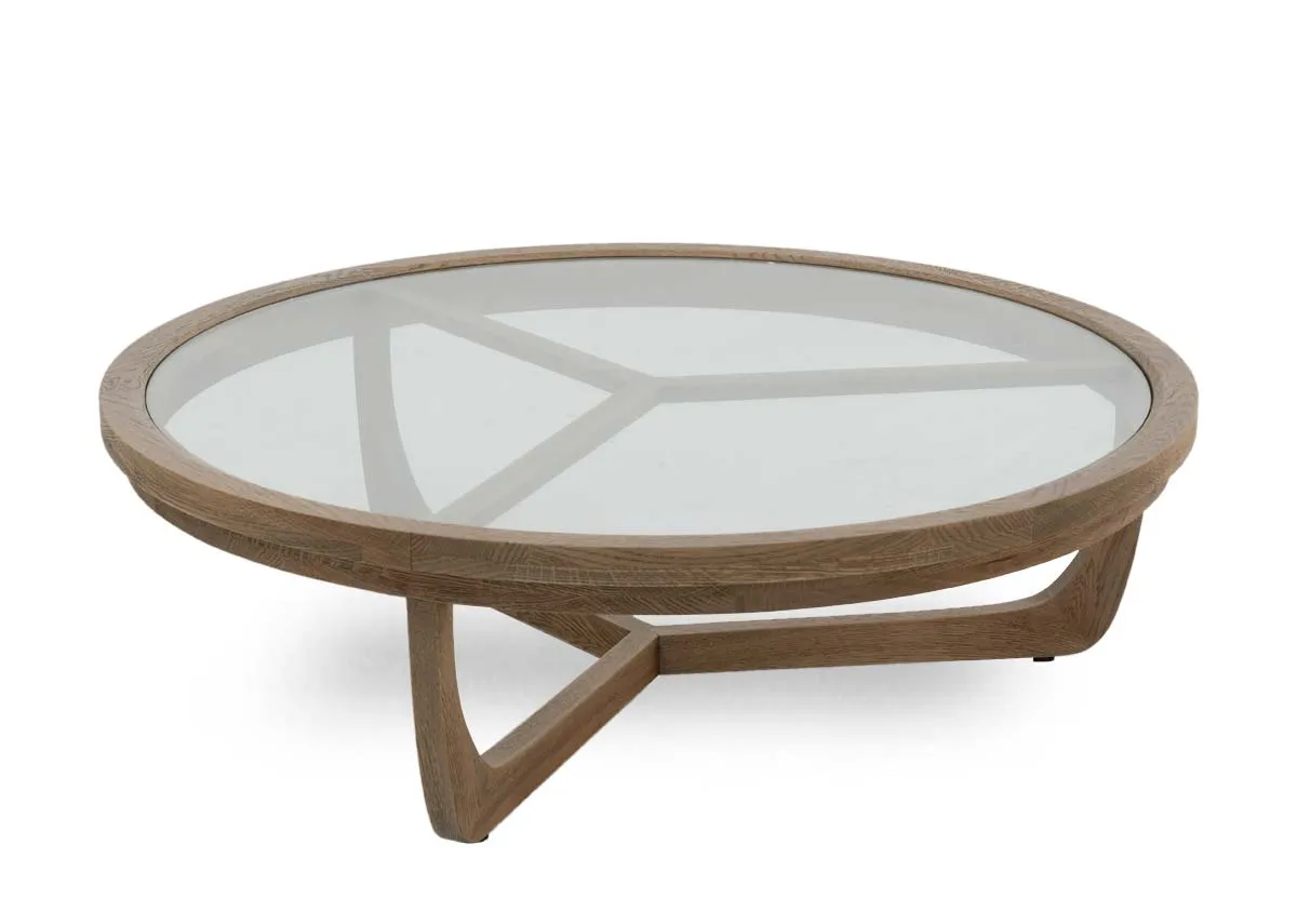 A round coffee table with oak frame and glass top from EZ Livings Alexis range. Angled view of low to ground table.