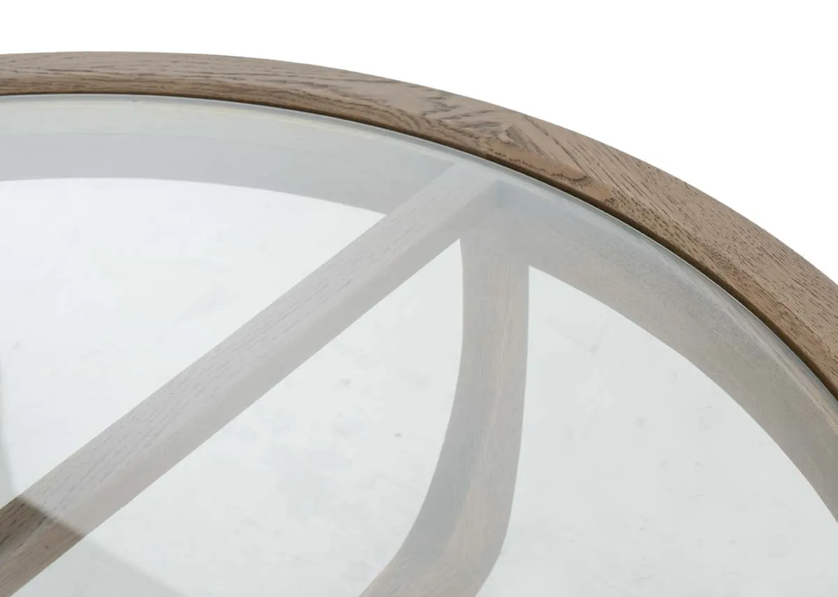 A round coffee table with oak frame and glass top from EZ Livings Alexis range. Closeup of wood frame detail