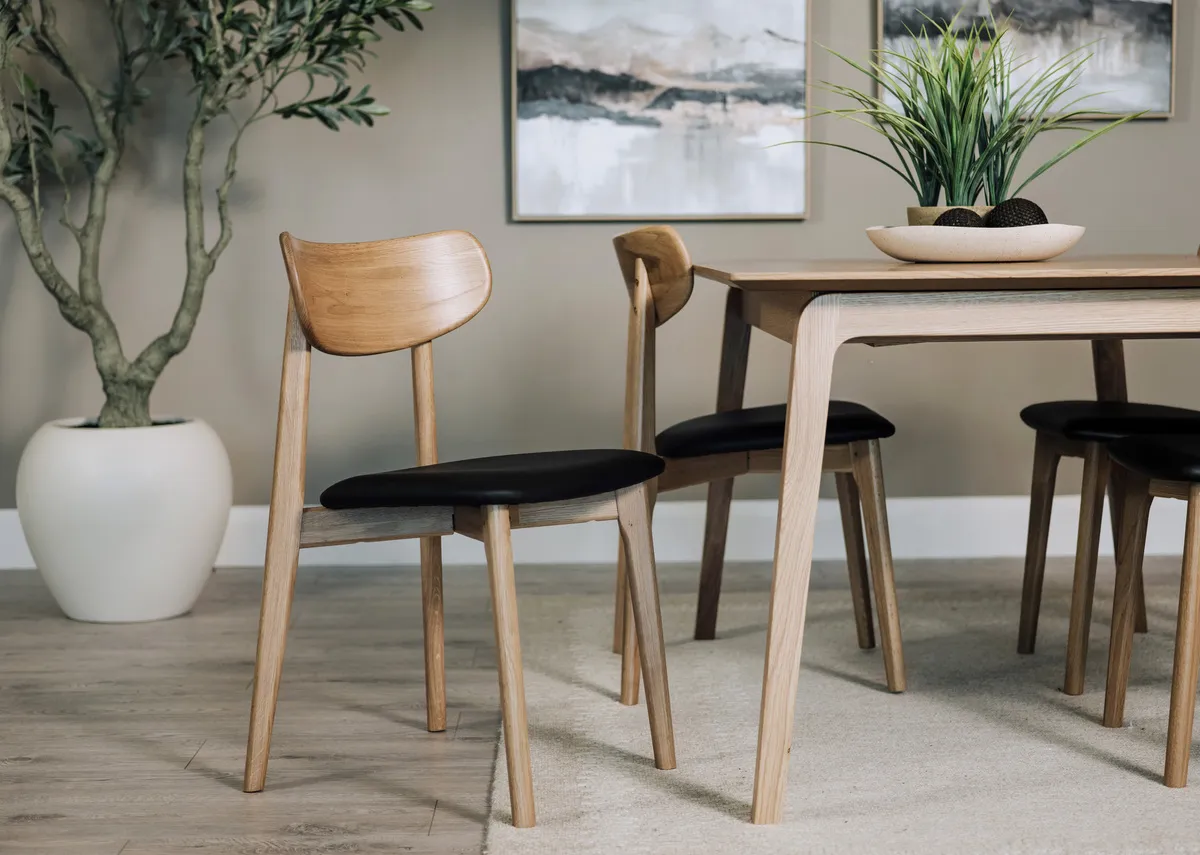 A lifestyle image of the Bari dining chair with matching dining table