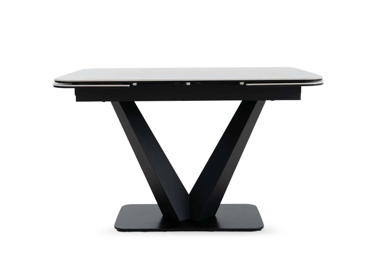 An off white cermaic top dining table from EZ Livings Tuscan range.Side view of the table not extended