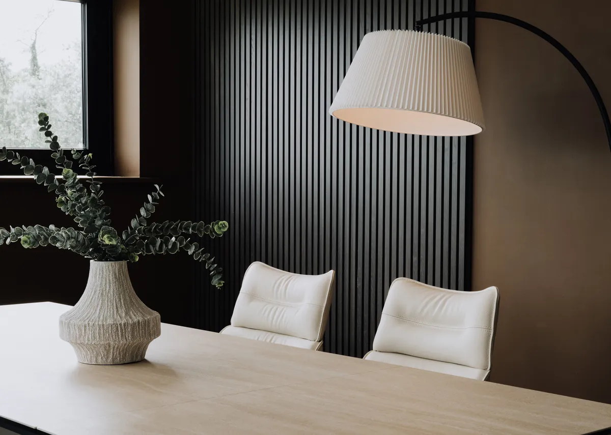 A lifestyle image of the Napoli dining table with closeup on the gloss table top