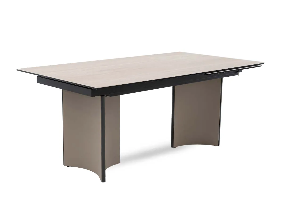 A beige ceramic table with revolving extension from EZ Livings Turin range. Angled view.