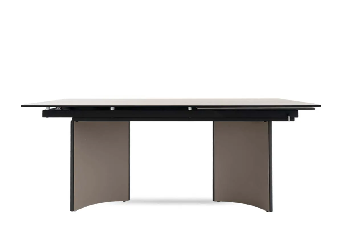 A beige ceramic table with revolving extension from EZ Livings Turin range.Side veiw of arced legs