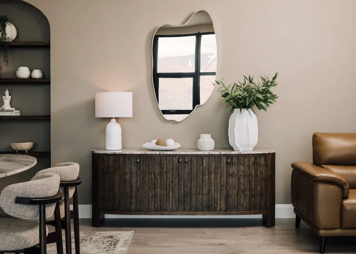 A lifestyle image of the Eden sideboard with doors closed .paired with the Eden dining table & hazel chairs.