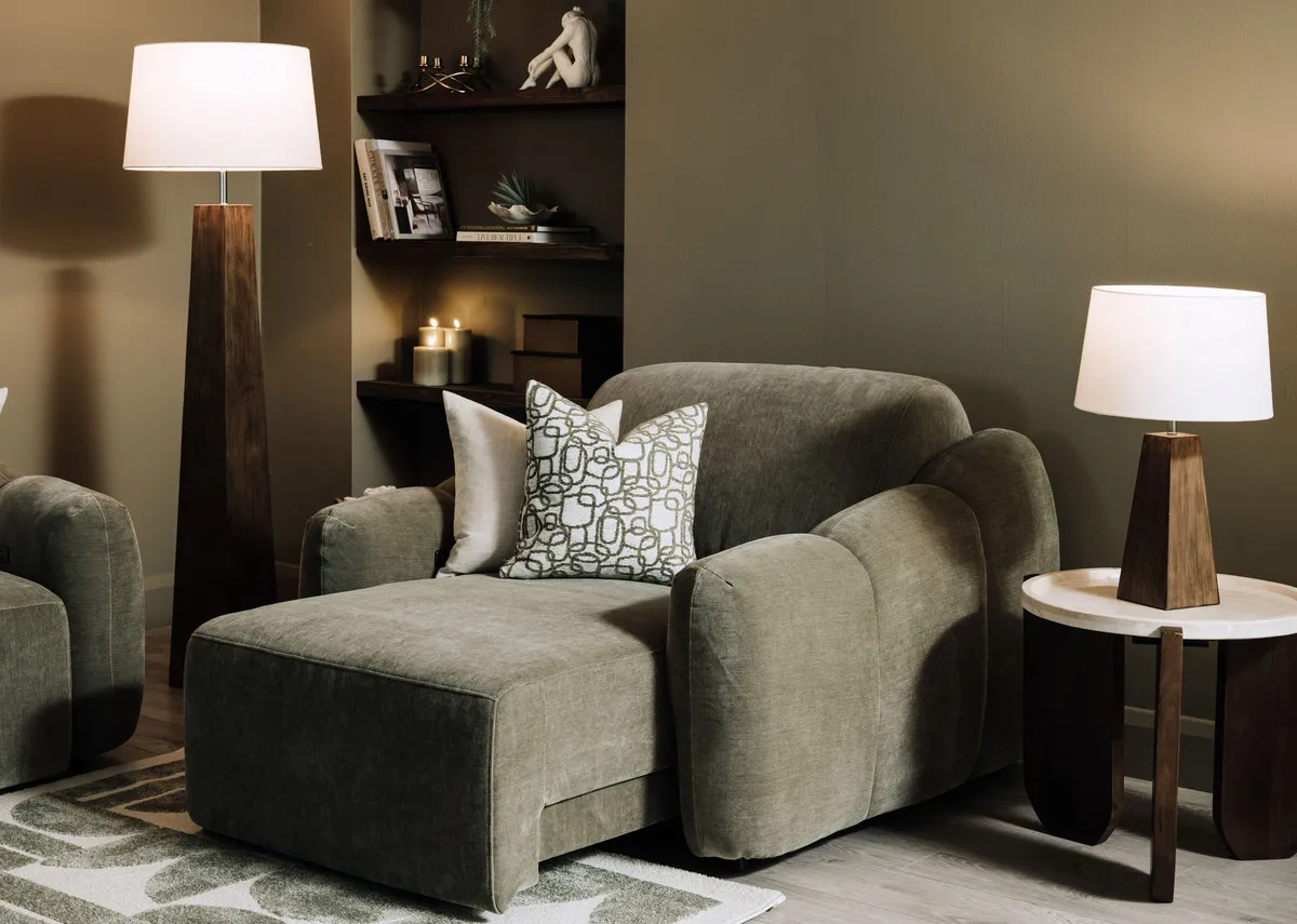 A lifetsyle image  of the Eleanor Green Recliner with carmen tables and Spruce trails cushion