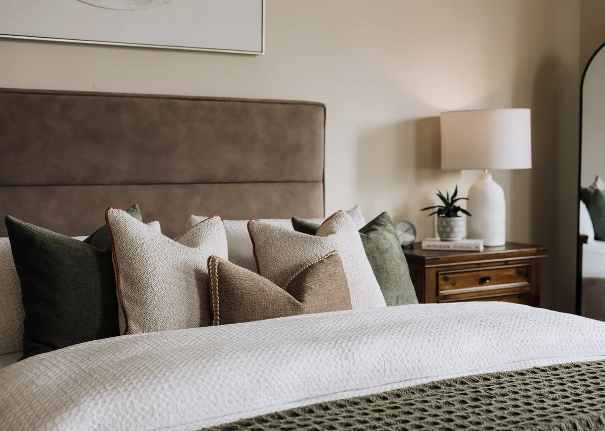 A lifestyle closeup of the fabric high headboard on the Ebony with Foxford Linens.