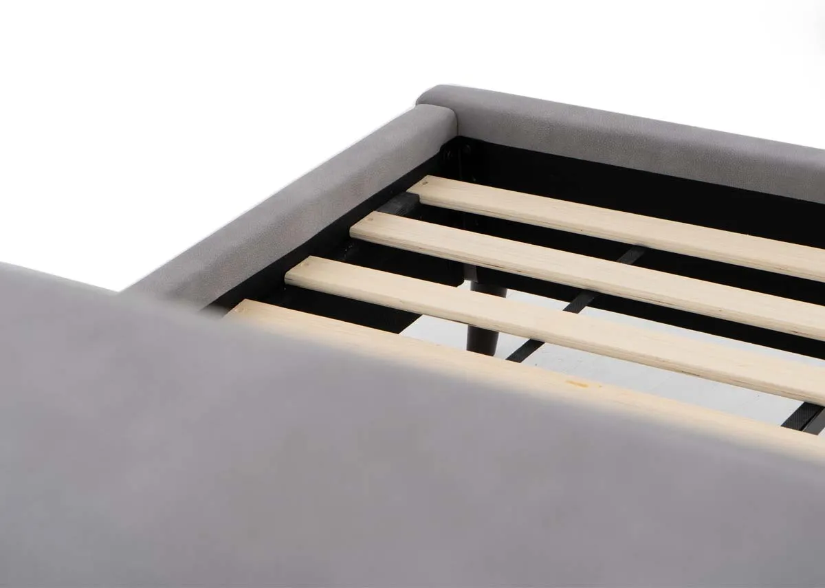 A light grey fabric bedframe from EZ Living Furniture. Closeup of wood slat base.