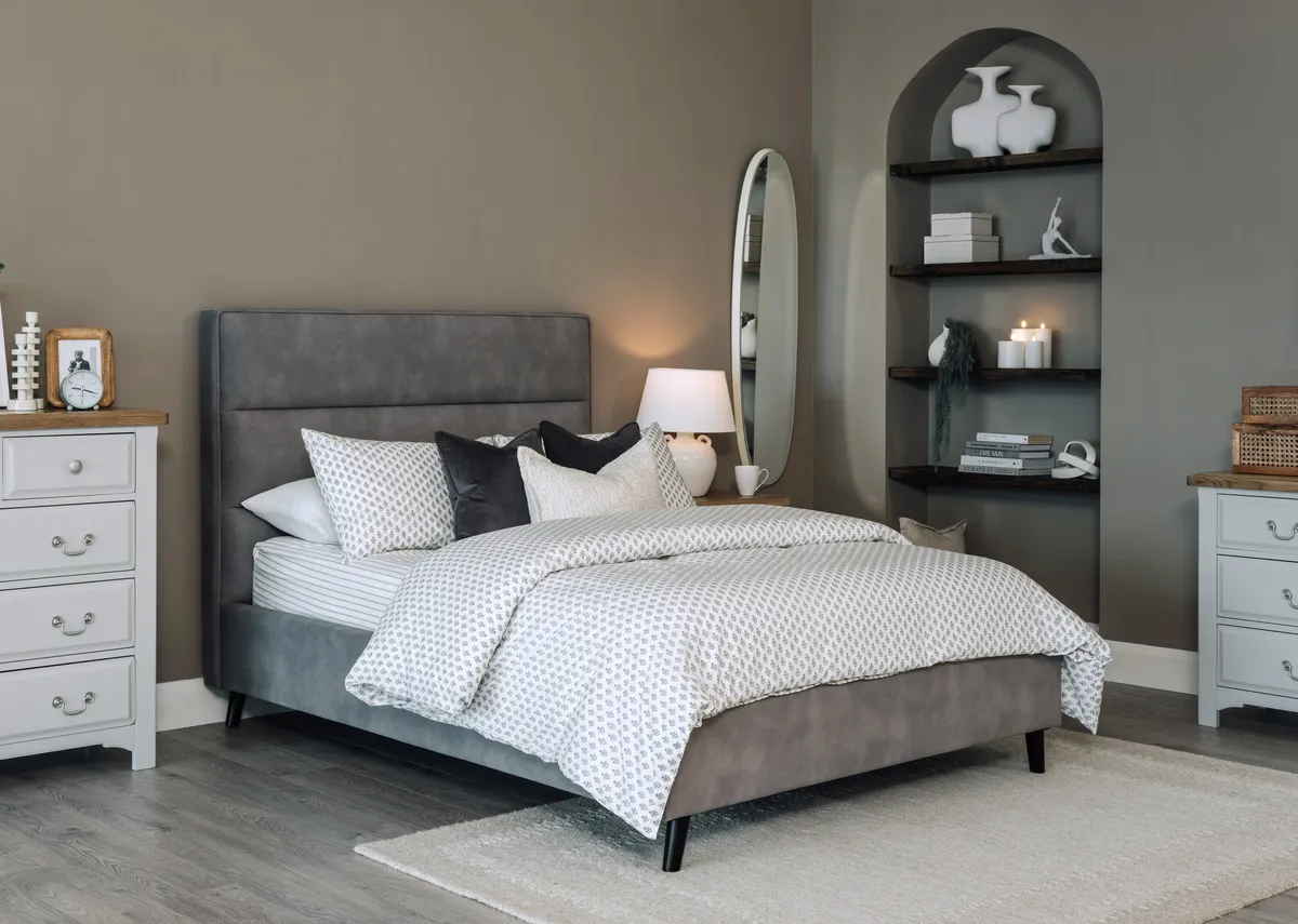 A lifestyle image of the Ebony grey bedframe with Georgia chest and locker with Lana wall mirror.
