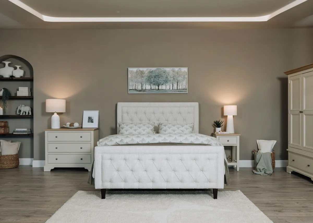 A 4ft6 double bedframe with high tufted head and footboard from EZ Livings Majestic range. Front view of panel detail at foot.