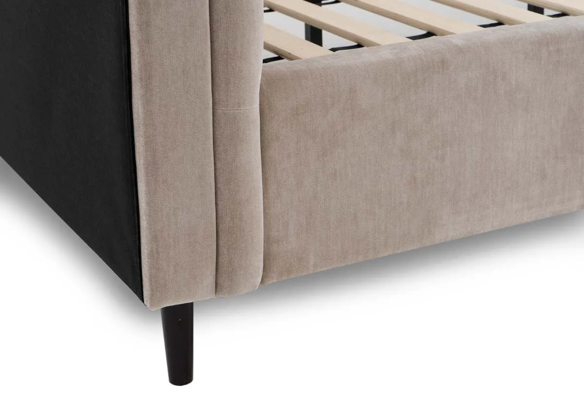 A double bed in taupe grey with button back detail from EZ Livings Sofia range. Closeup of black leg