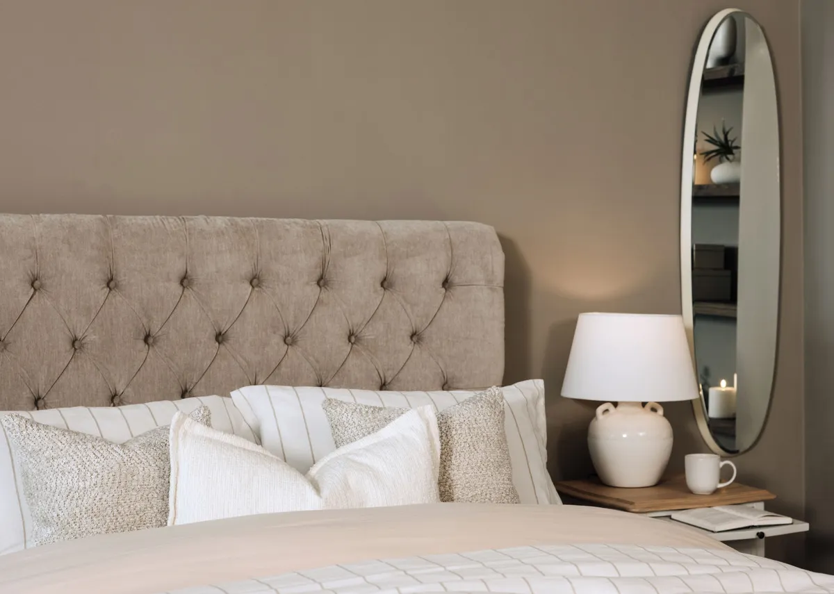 A lifetsyle image of the Sofia taupe bedframe with Amelie chests and Lana mirror.