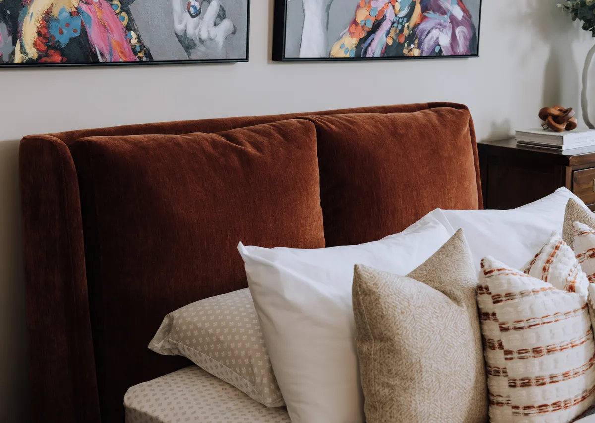 A lifestyle image of the Comfy rust bedframe with Mia pillowcase and a selection of cushions