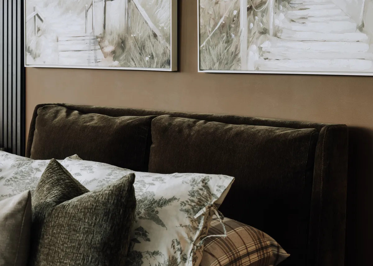 A lifestyle image of the Comfy ottoman headboard closeup with a padded velvet fabric finish.