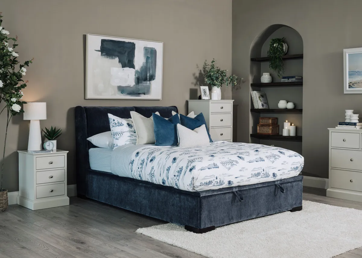 A lifestyle image of the Comfy blue ottoman bed fixed with riverndale locker and chests.