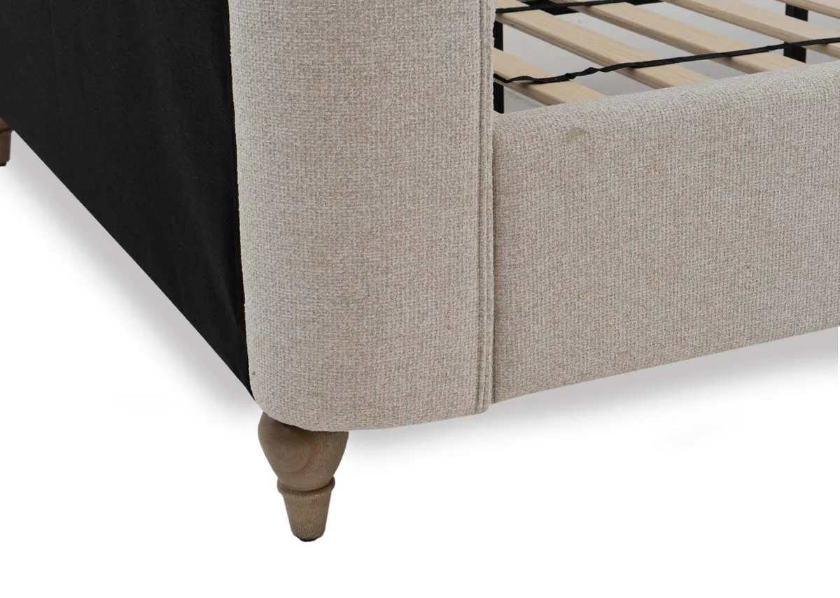 A cream fabric bed frame from EZ Livings Chelsea range. Closeup of ash wood feet