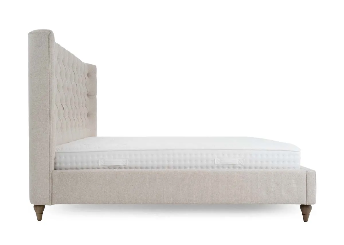 A cream fabric bed frame from EZ Livings Chelsea range. Side view of upholstered sides.