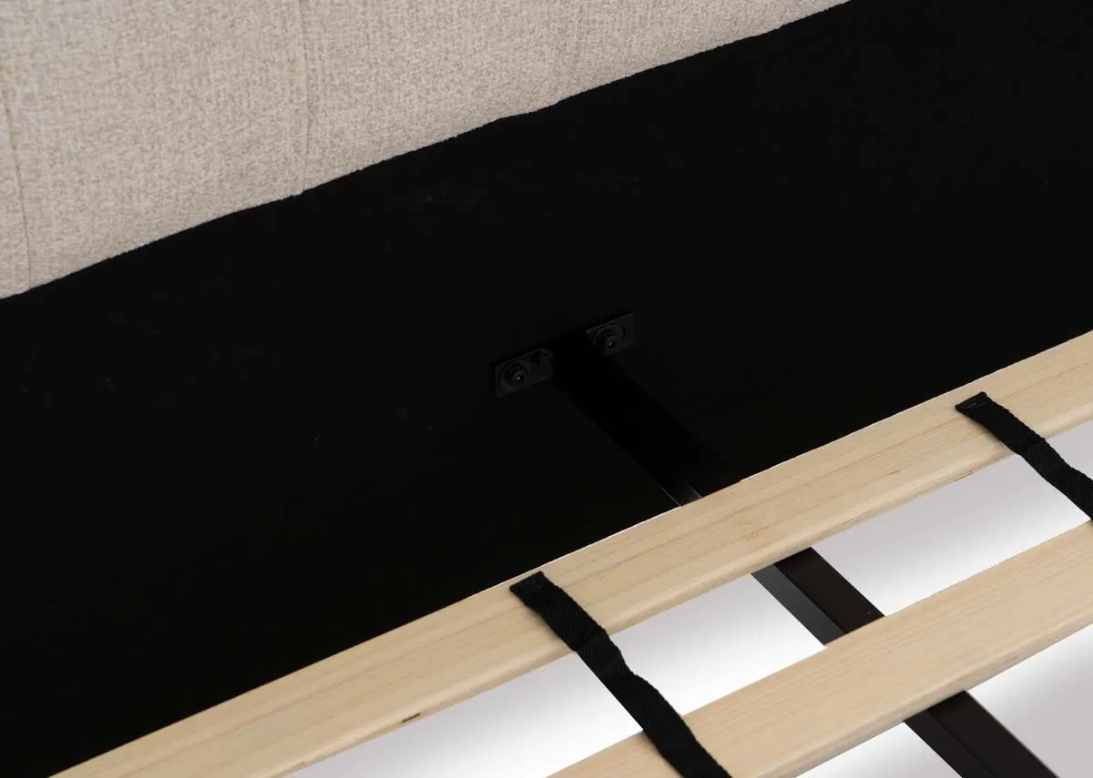 A cream fabric bed frame from EZ Livings Chelsea range. Closeup of slat wood base.