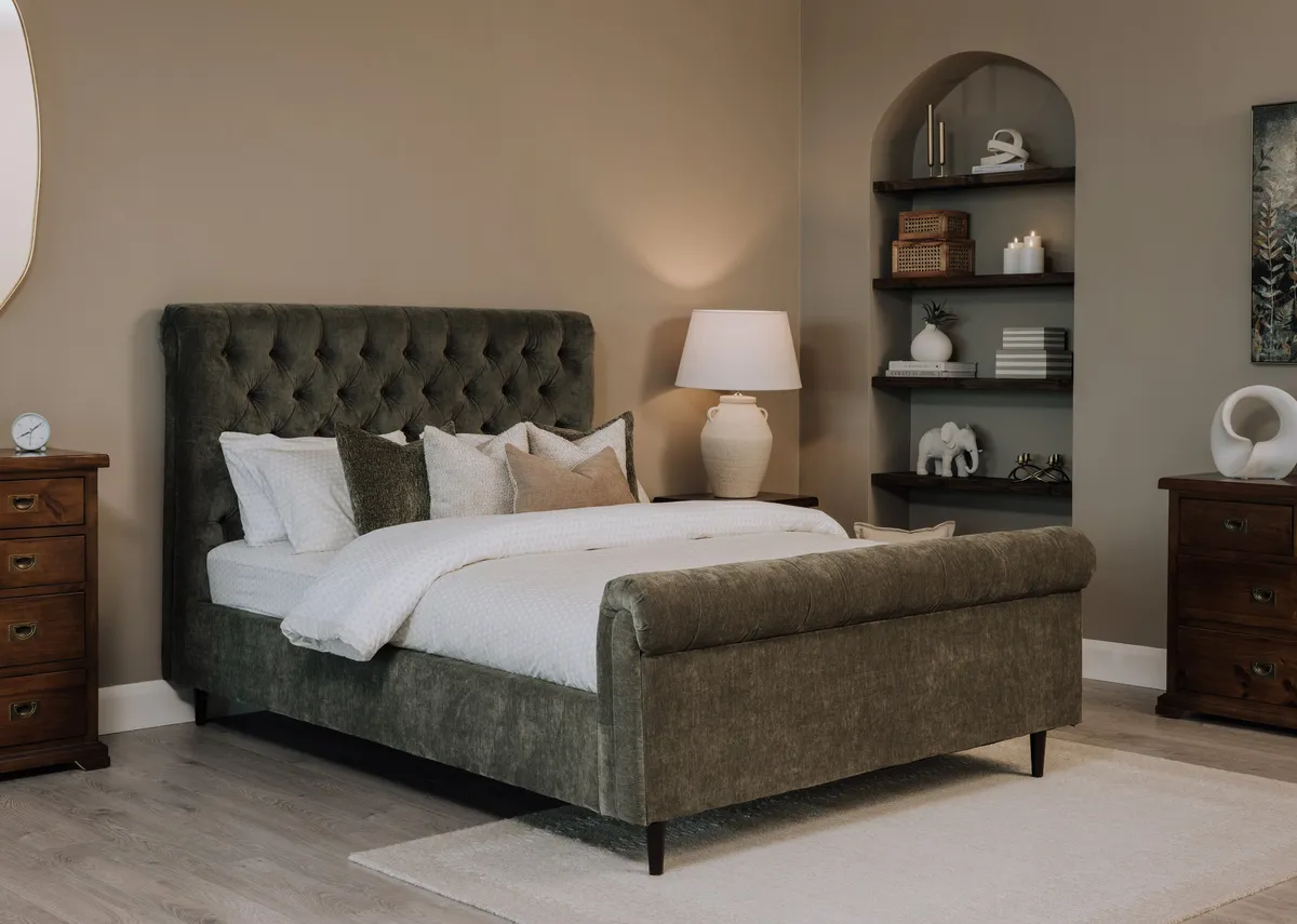 A lifetsyle image of the Sofia green bed frame in green with the Aisling chest and locker with Mia duvet set by Foxford.