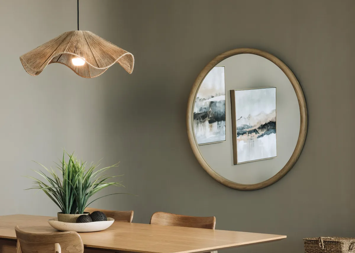 A lifestyle image of the Prom mirror with Bari dining set and Misty View pictures