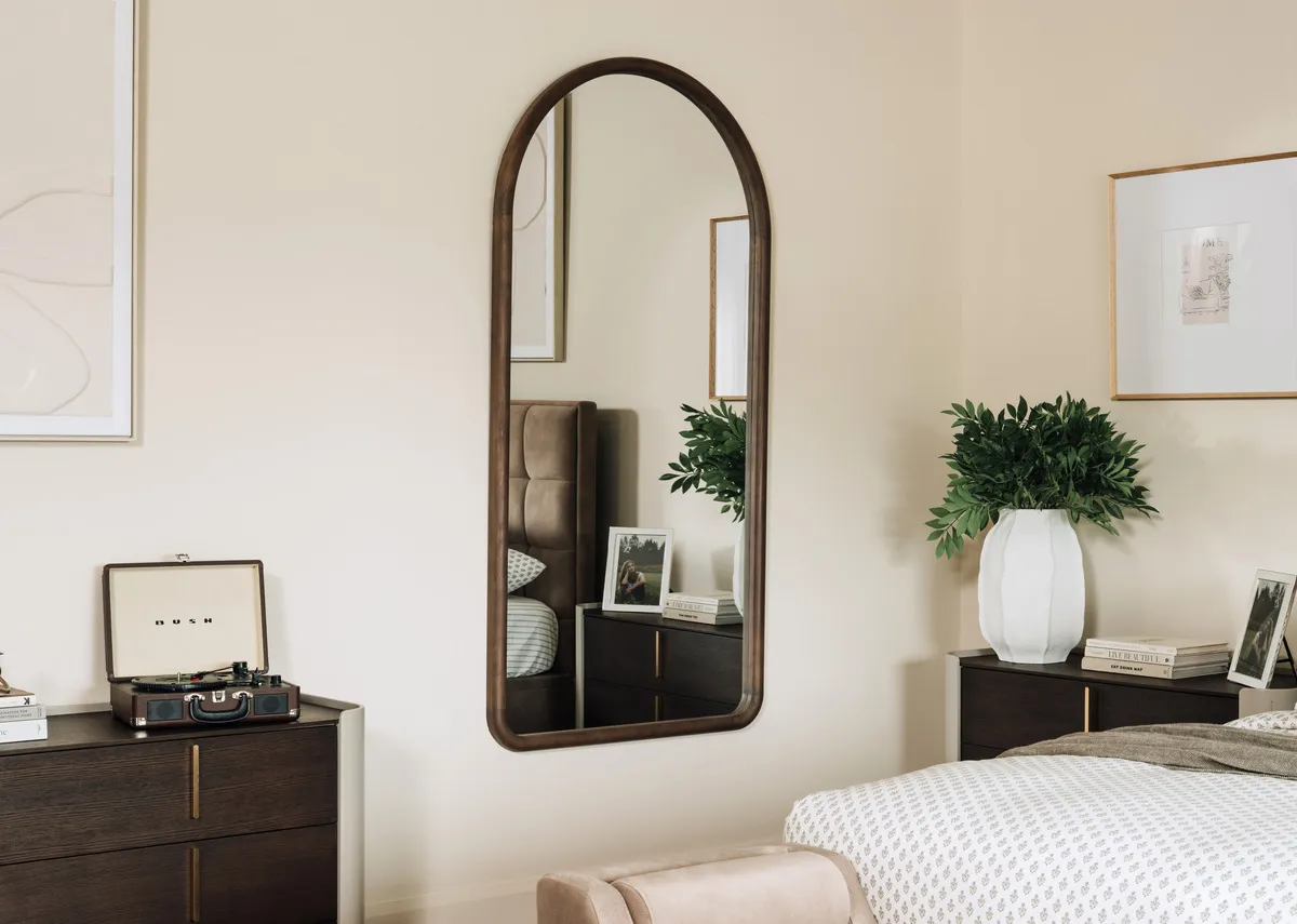 A lifestyle image of the Quays mirror ith Canna dresser and Sadie Ottoman.