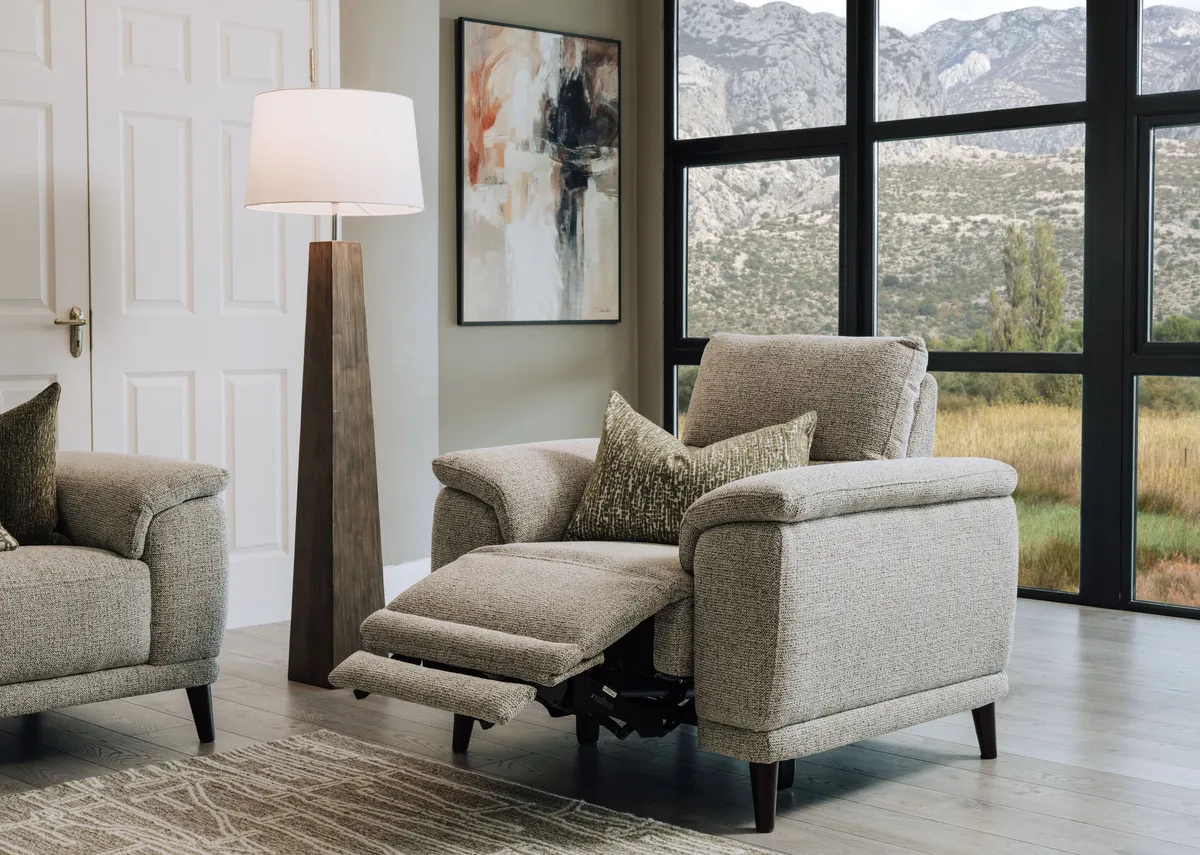 A lifestyle image of the Savoy fabric recliner in action with the Fauna lamp.