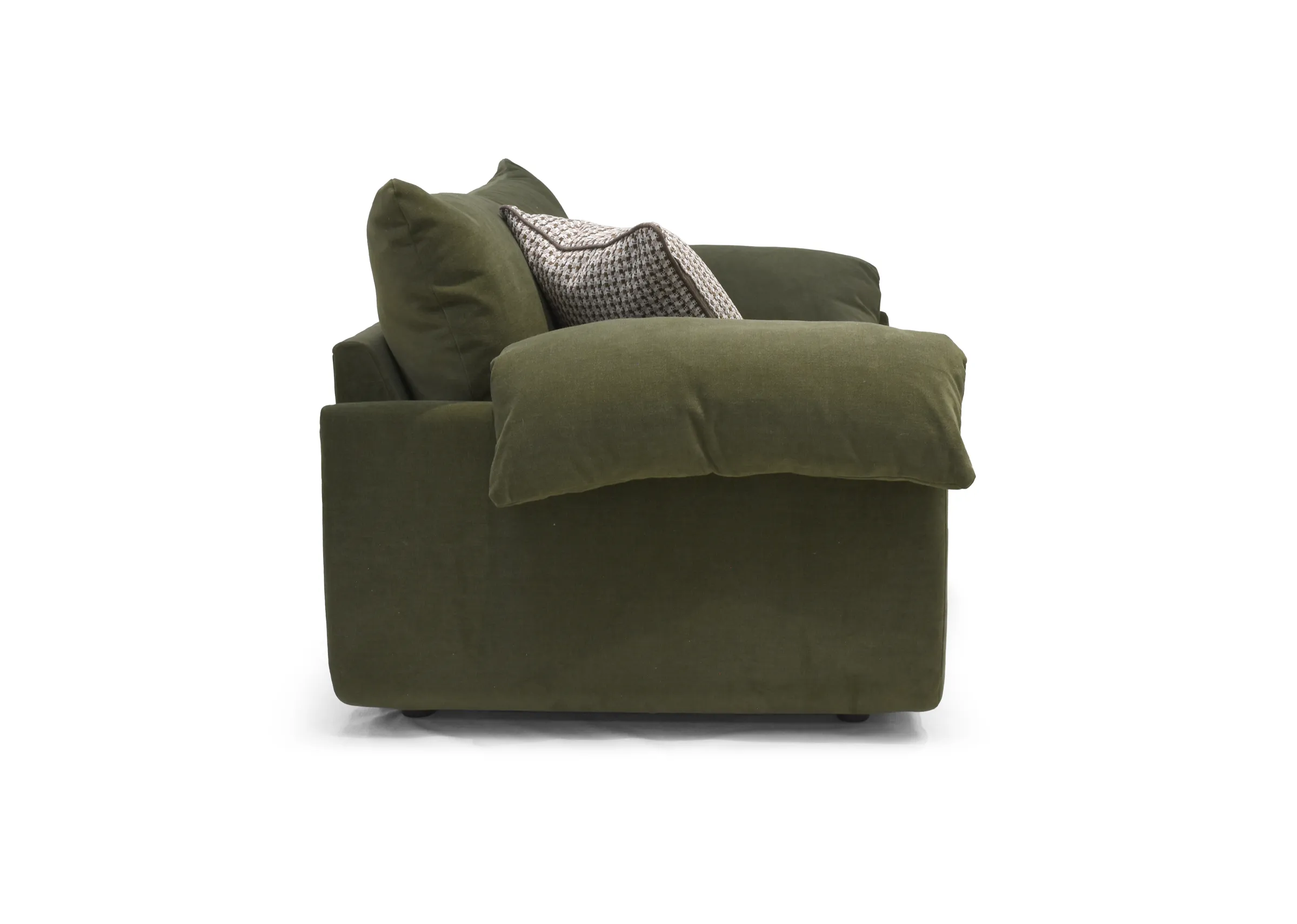 A large green fabric sofa from EZ Livings Bayswater range. Side view of arm cushions with overhang