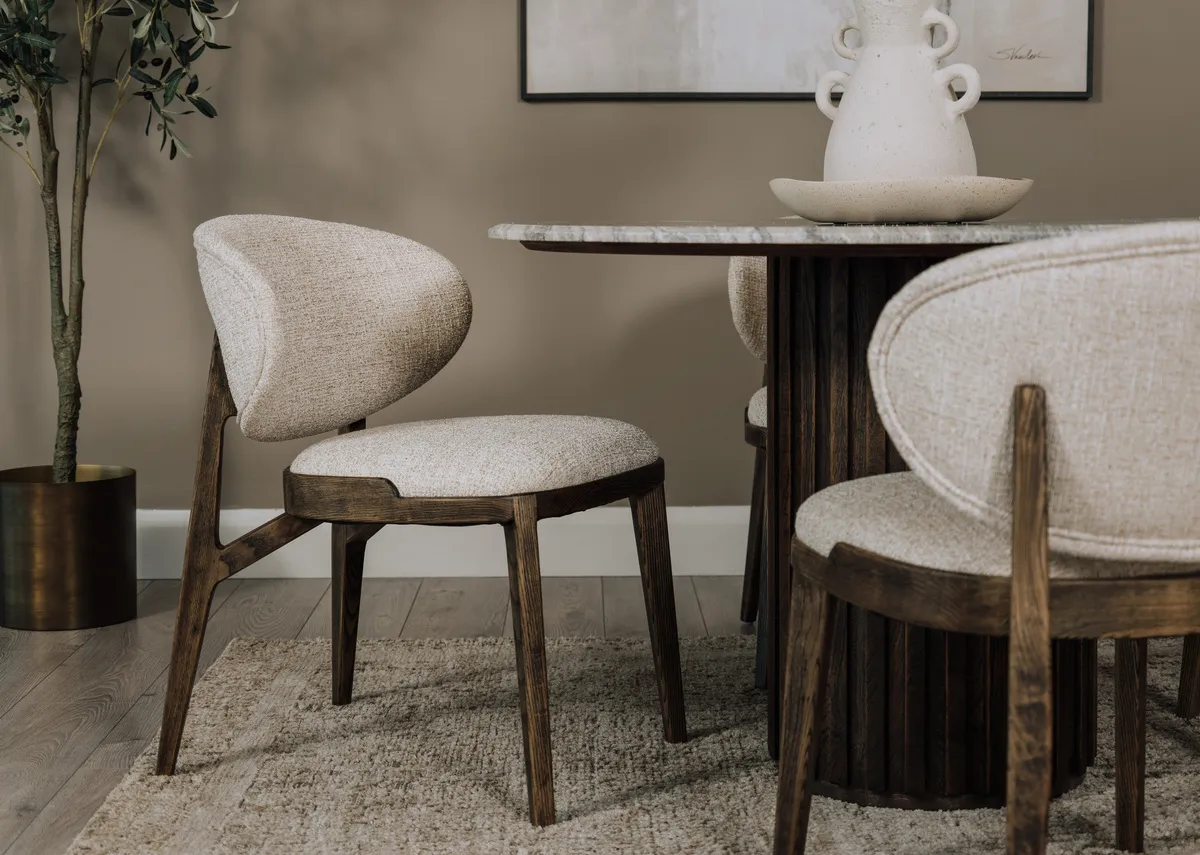 A lifestyle image of the Eden dining chair with matching rounds dining table with marble top.