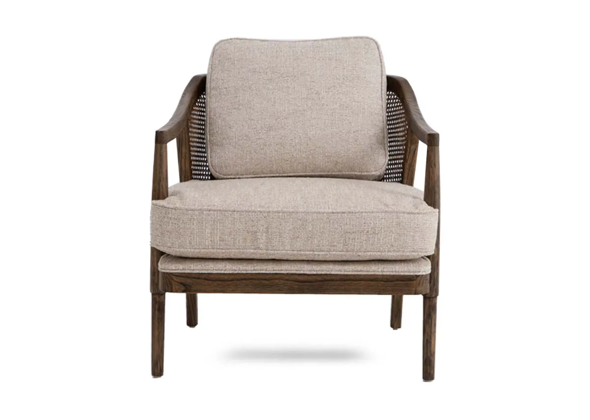 A beige fabric occasional chair from EZ Livings Roundstone range.Front view of wooden framed chair with rattan detail back.