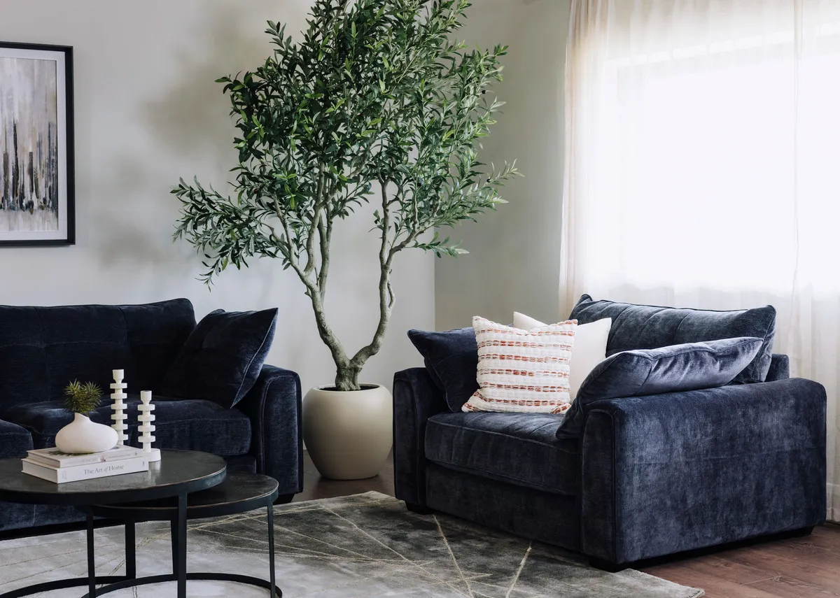 A lifestyle image of the Darcy cuddler with Toko tables and Olive plant