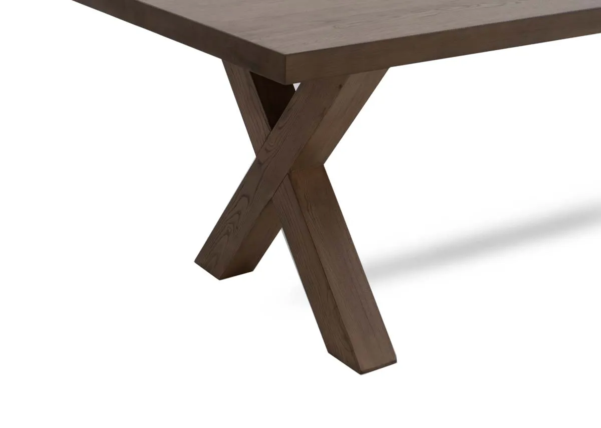 A grey brown ash wood dining table with x legs from EZ Livings Geneva range. Closeup of x legs