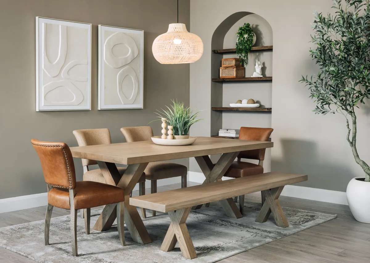 A lifestyle image of the Genva dining table and leather & fabric chairs with bench and Gateway pictures.
