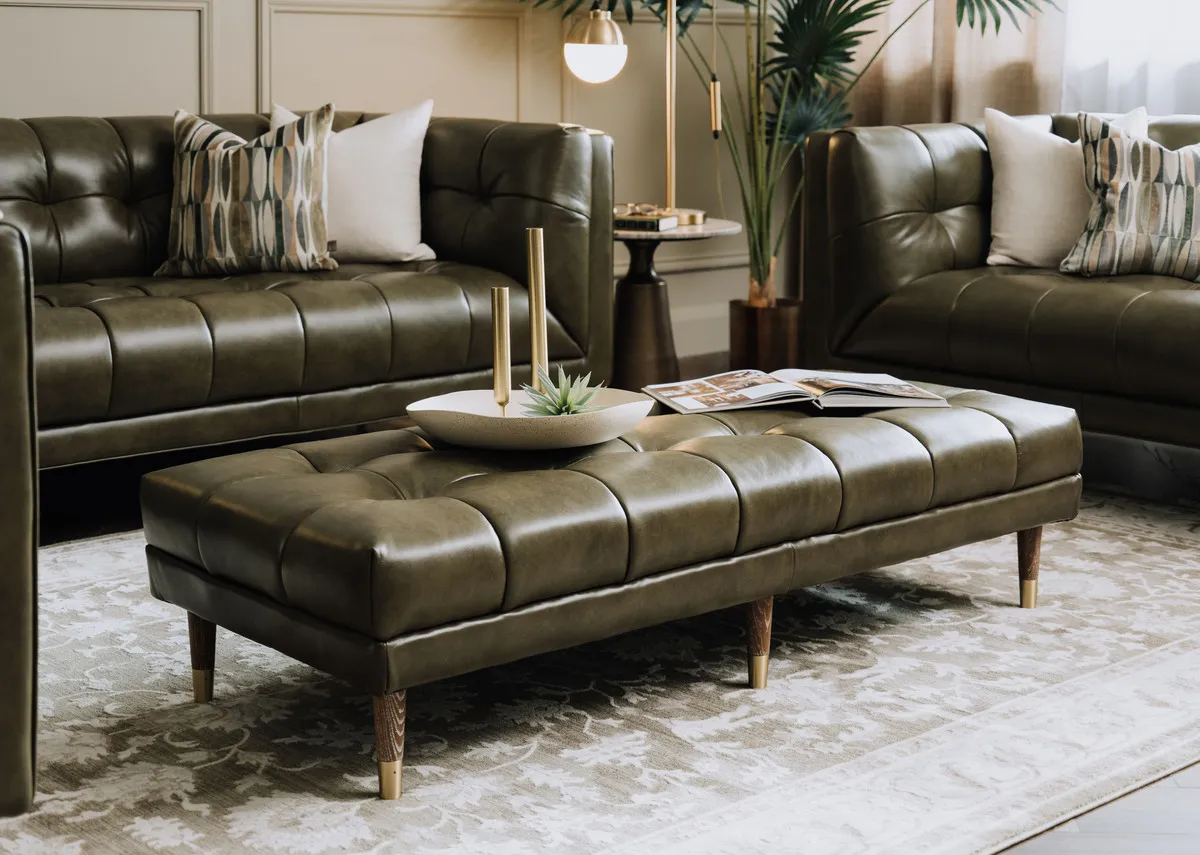 A lifestyle image of the Grace green leather footstool with sofas with pyramid side tabe and Casper lamps with Arden rug.