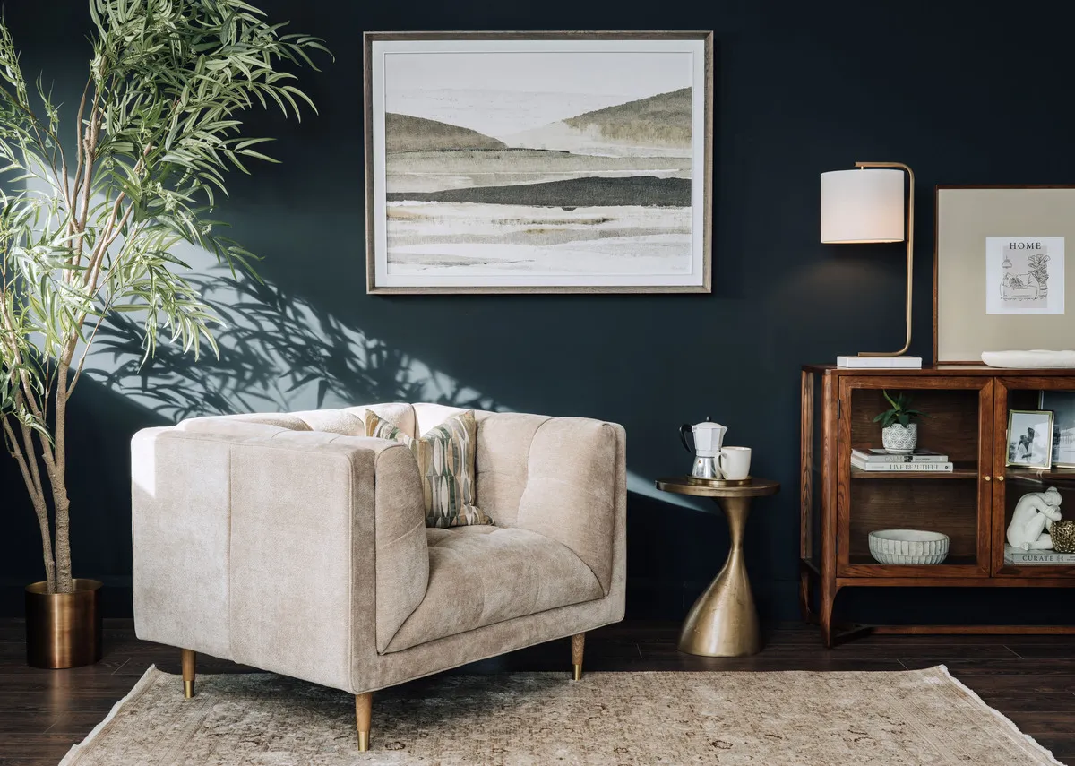 A lifestyle image of the Grace beige armchair with Cameo sideboard and Morning mirage print.