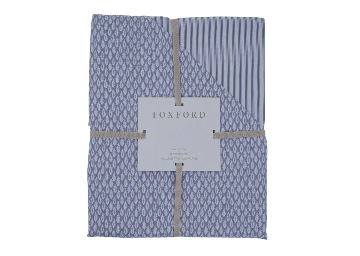 A blue & white reversible duvet cover set from Foxford with 2 pillowcases .