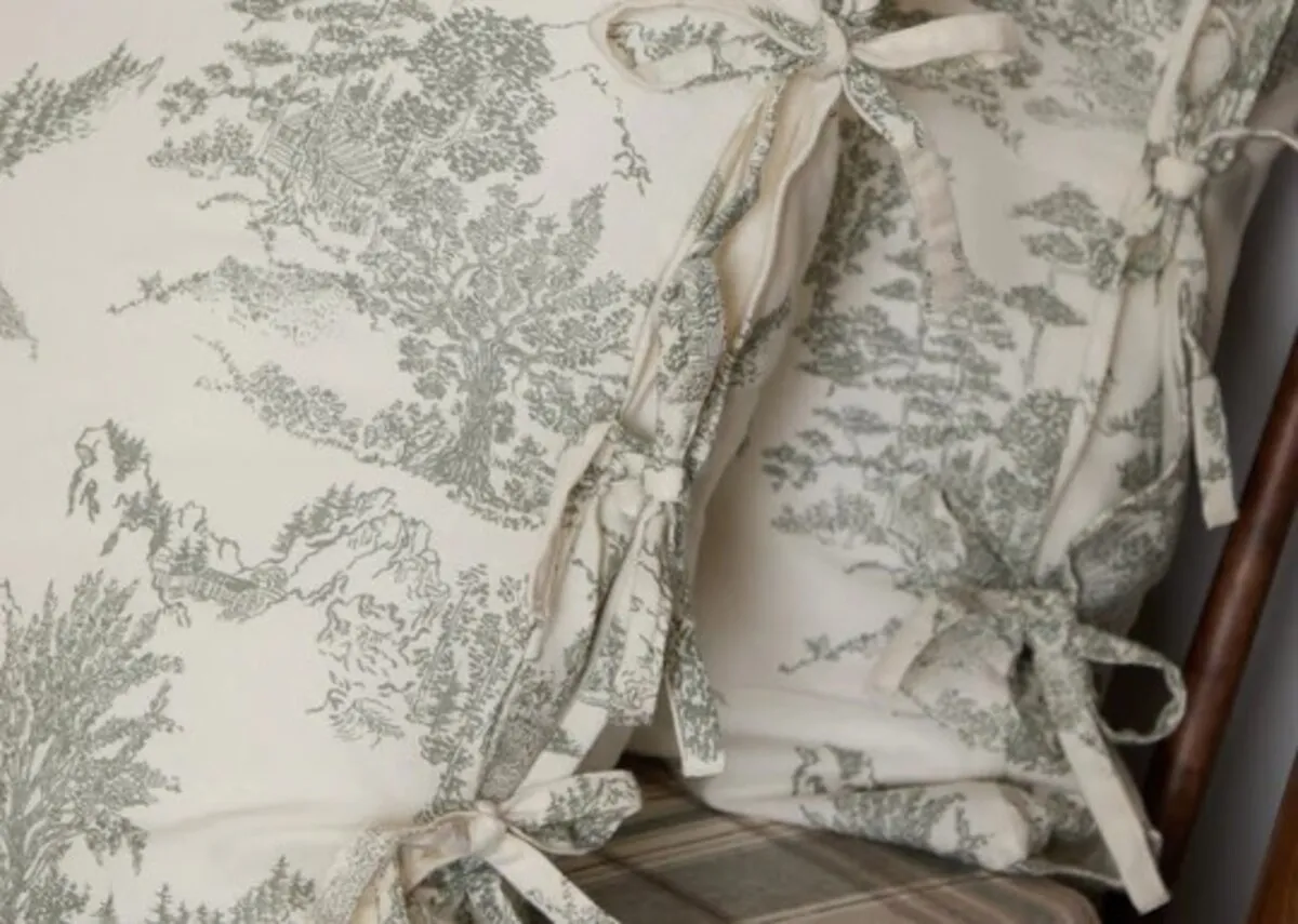 A lifestyle image of the Eve toile pillow cases with tie strap detailing on the sides.