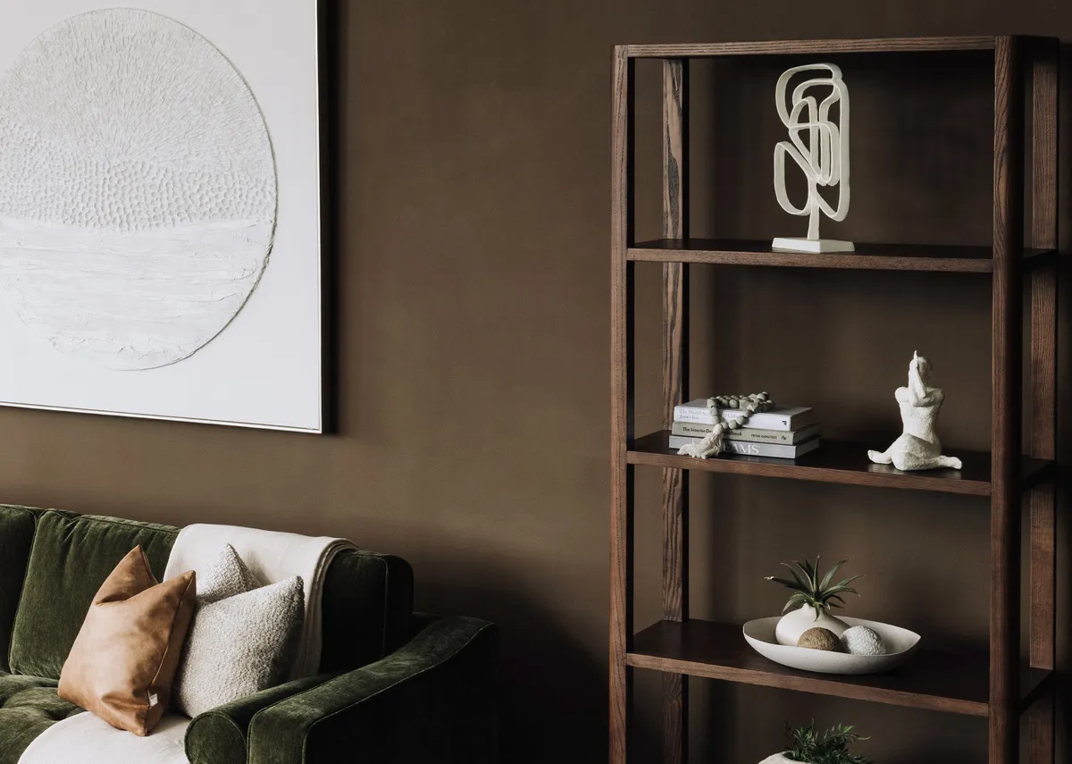 A lifestyle image of the Cameo bookcase with a selection of ornaments and dishes including the Yoga ornament.