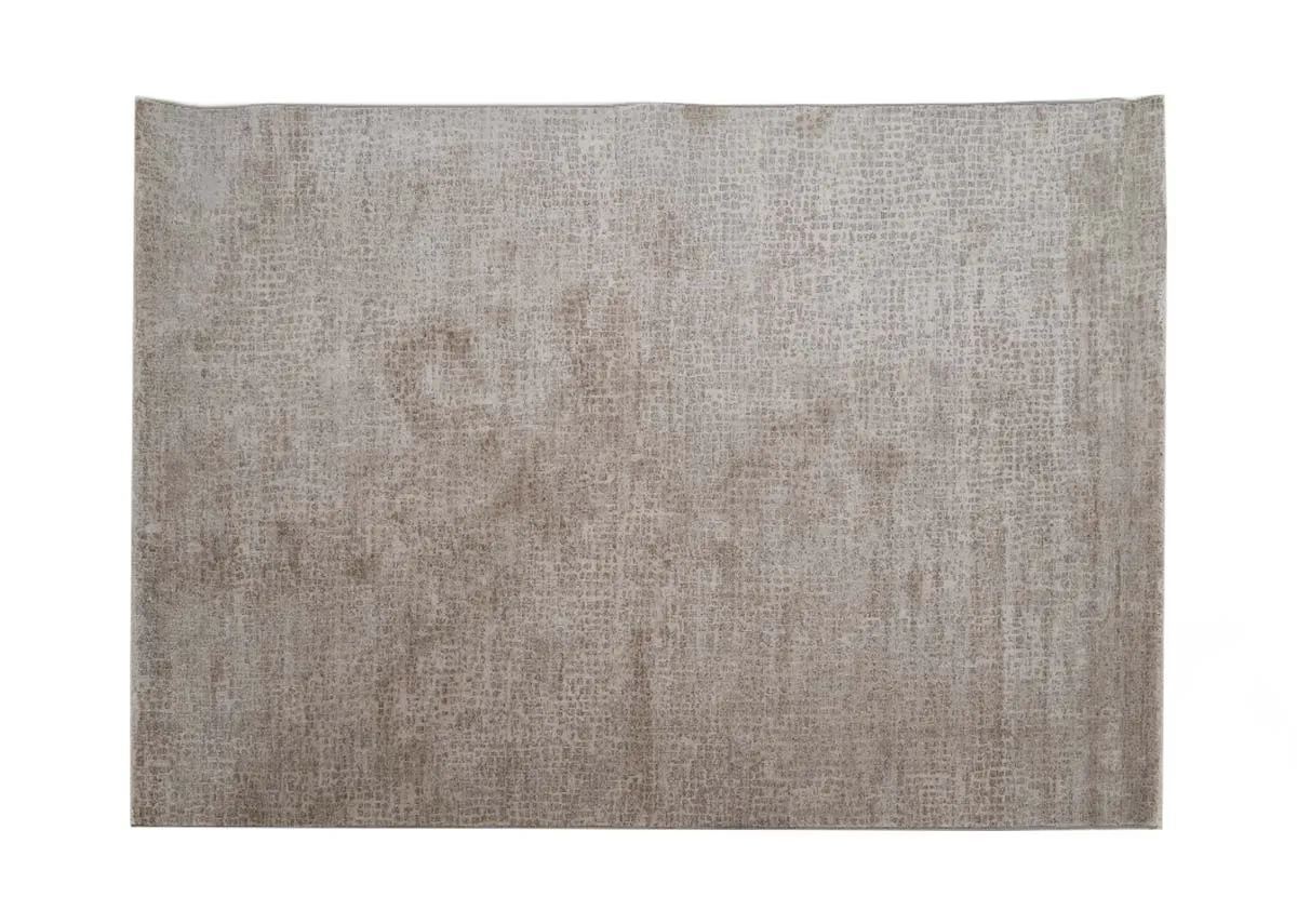 A beige and taupe distressed rug from EZ Livings Flowline range. Closeup of fringe detail on border