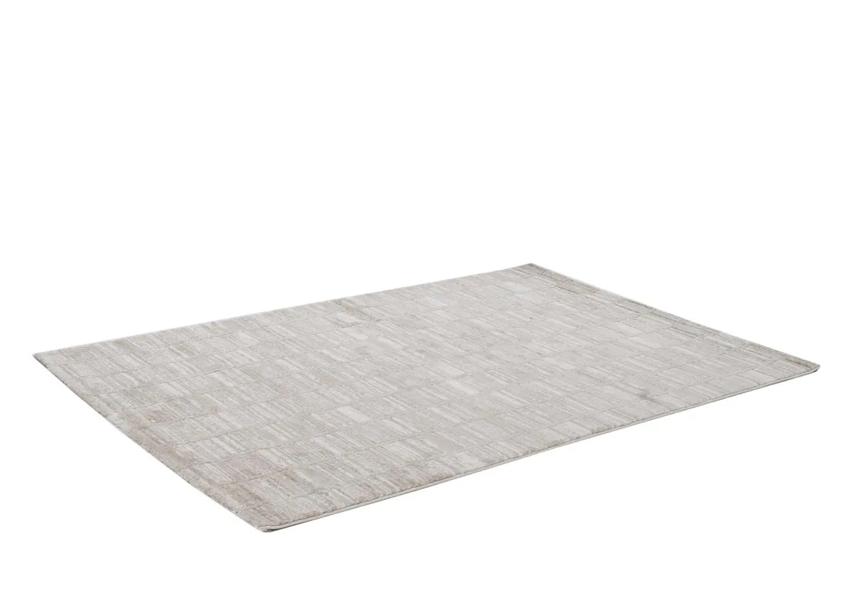 A beige and taupe distressed rug from EZ Livings Sable range. Closeup of underlay and pile detail on border