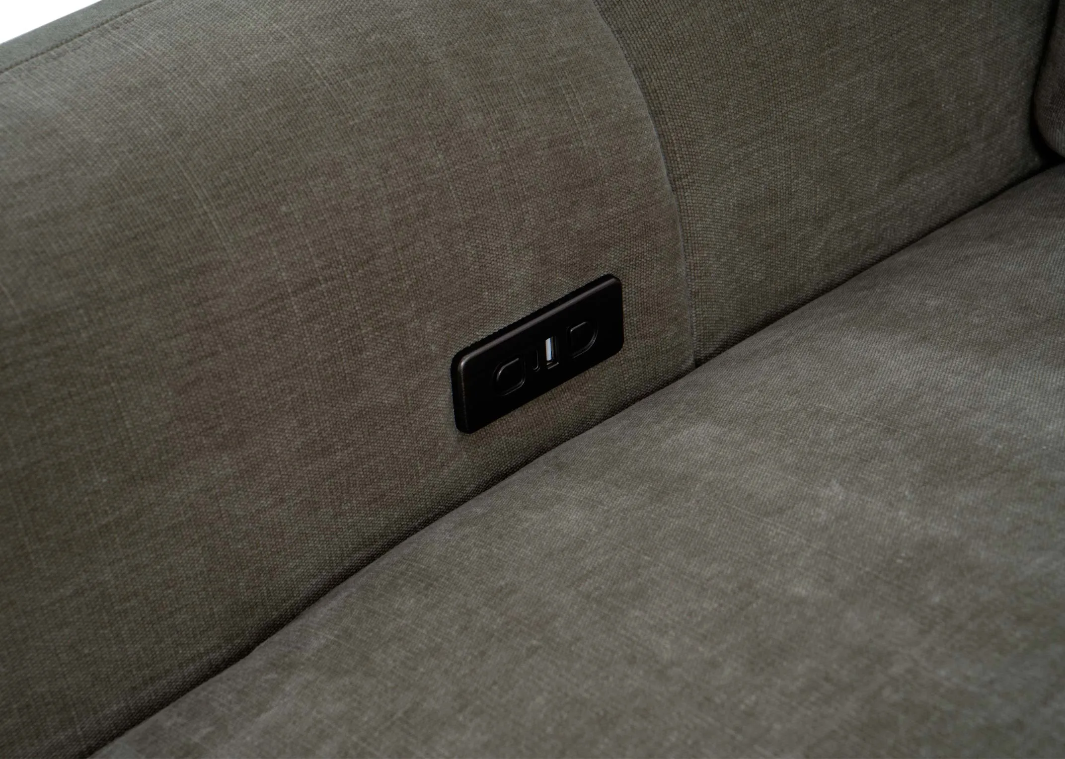 A green sofa from EZ Livings Eleanor range. Closeup of button and usb charging point on inside of arm on both sides.