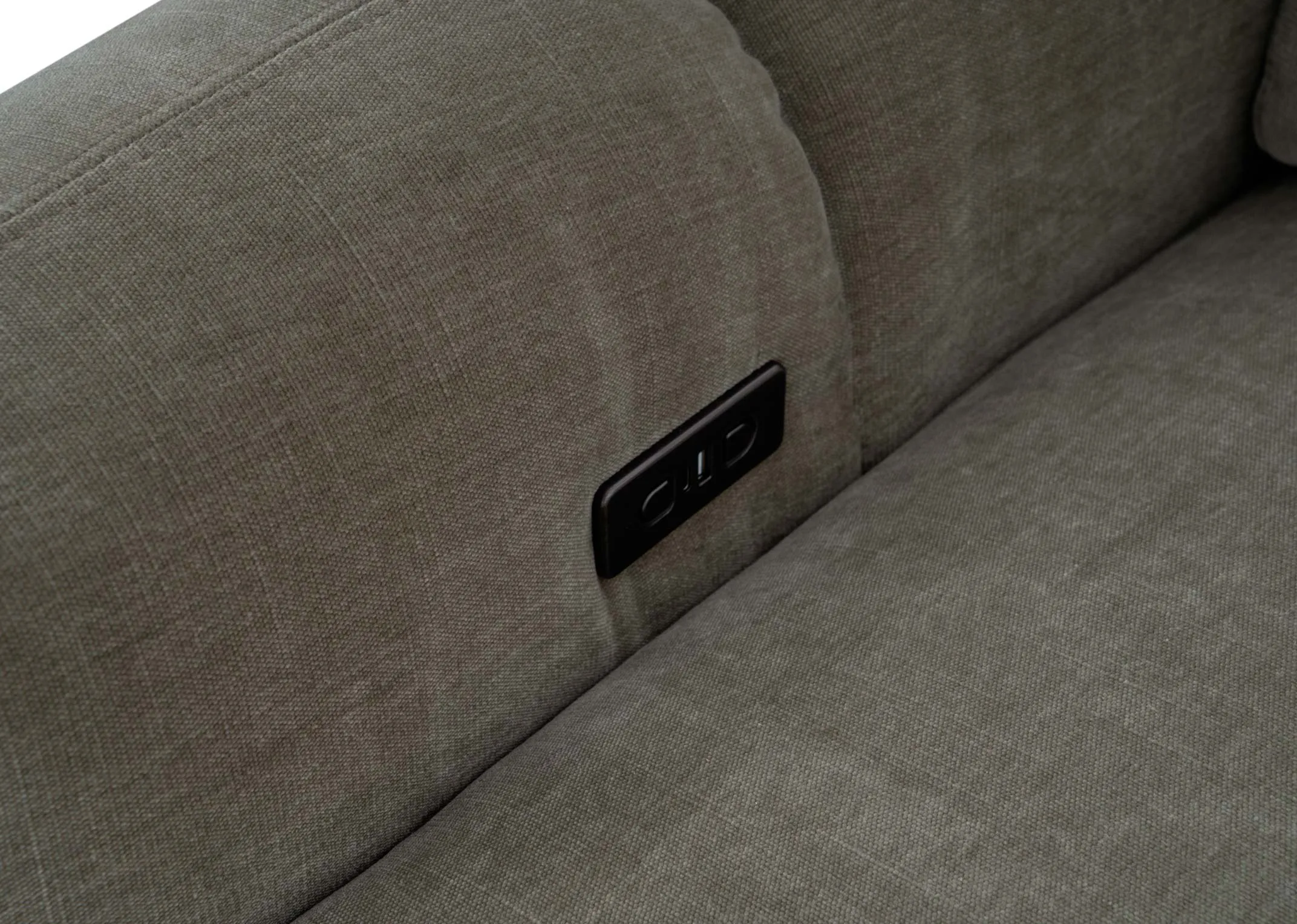 A green armchair from EZ Livings Eleanor range. Closeup of button and usb charging point on inside of arm on both sides.