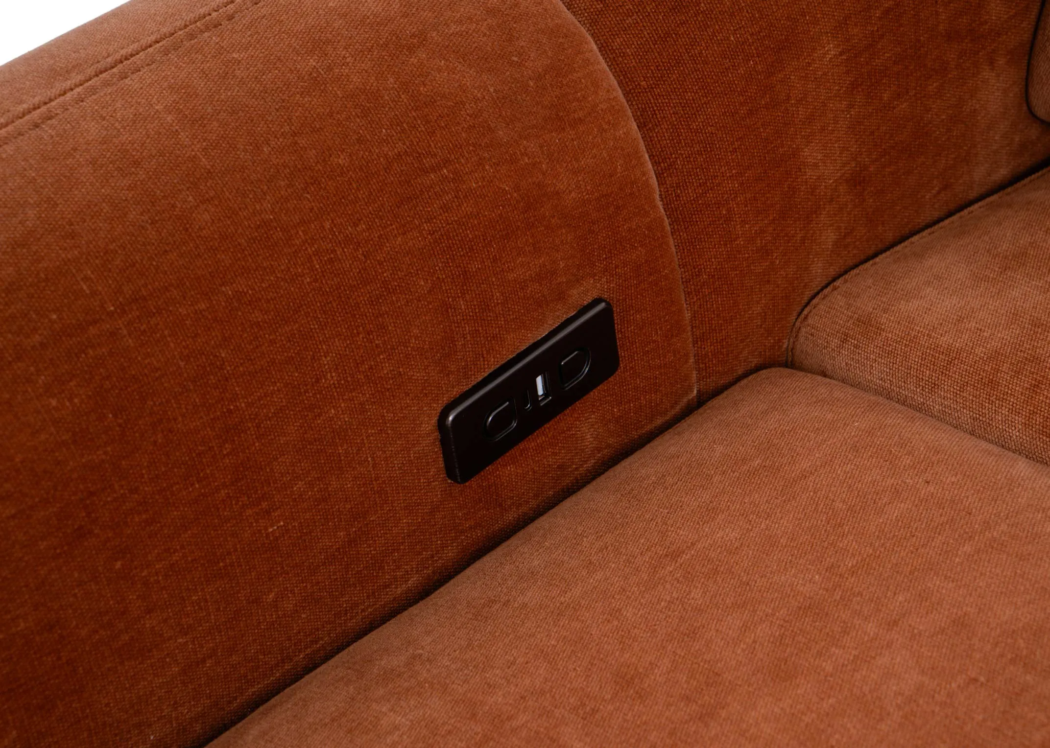 A rust orange armchair from EZ Livings Eleanor range. Closeup of button and usb charging point on inside of arm on both sides.
