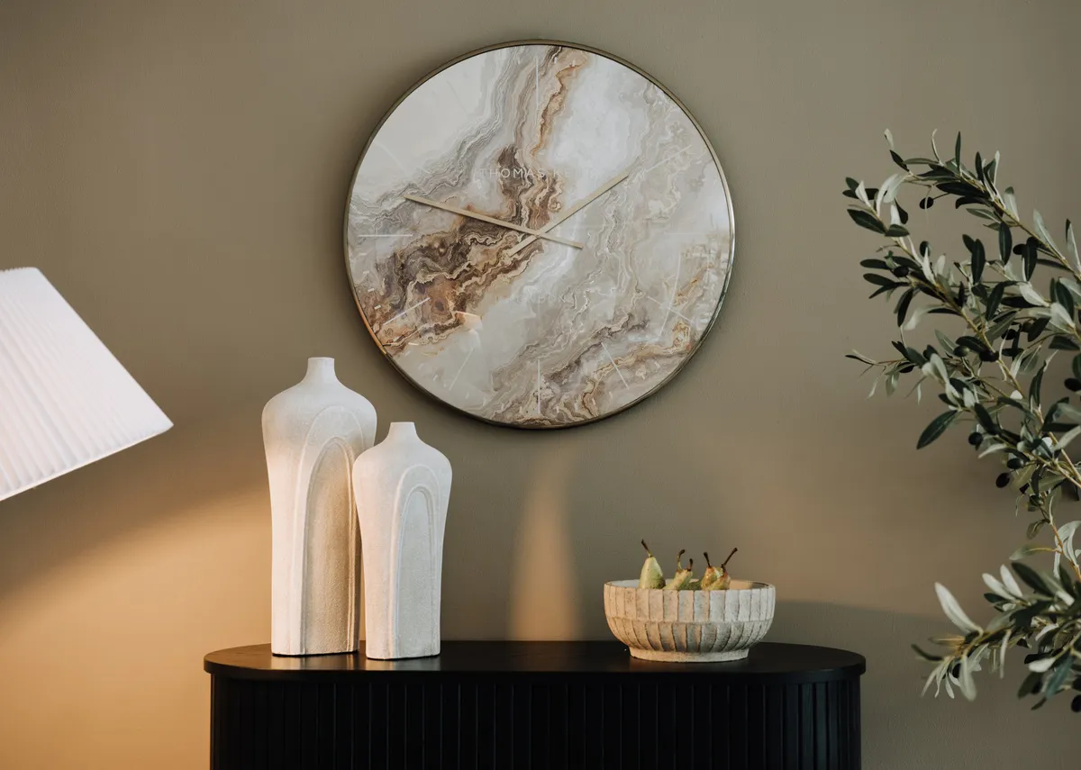 A lifestyle image of the Nola sideboard with Oyster clock with Snowdrop vases and Elder bowl