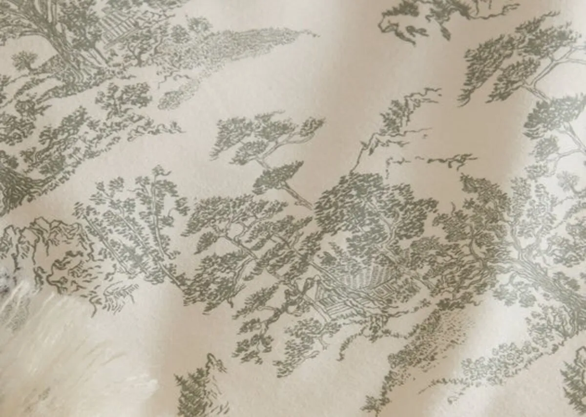 A lifestyle image of the Eve toile duvet set with a closeup on the green antique patterm