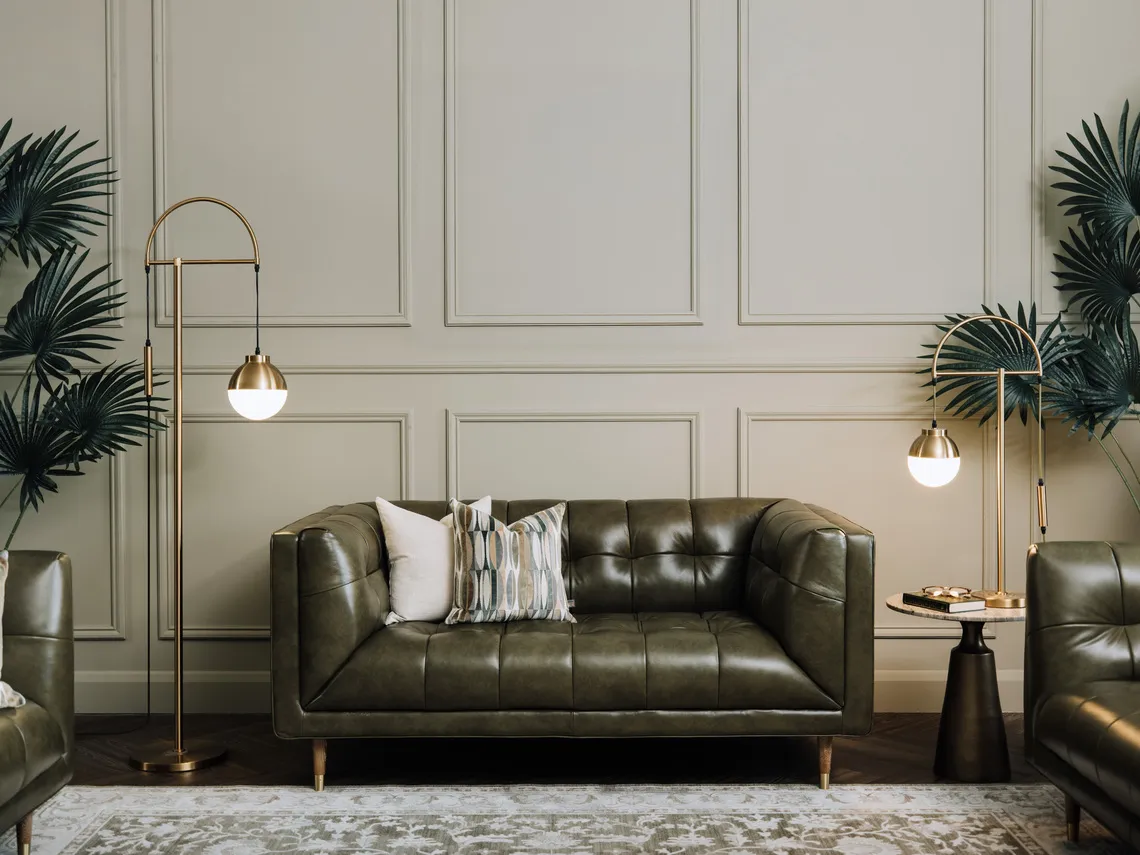 A lifestyle image of the Grace green leather sofa with pyramid side tabe and Casper lamps with Arden rug.